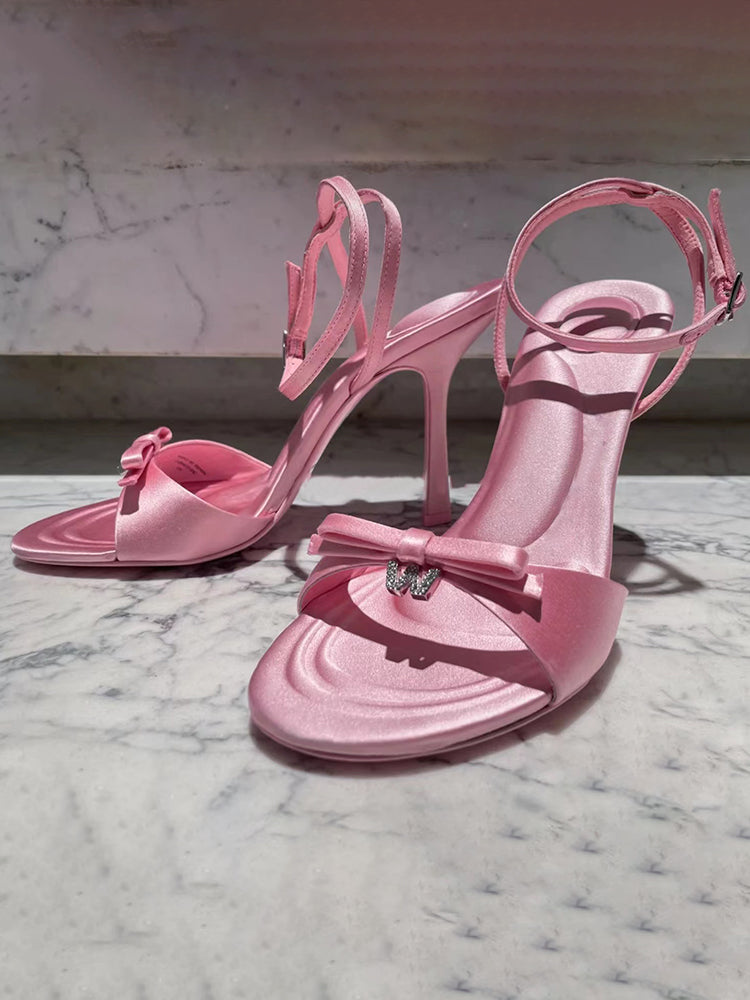 Silk satin drop-toe stiletto pumps with bow and rhinestone letters
