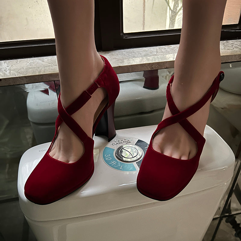 Red cross-strap round toe pumps