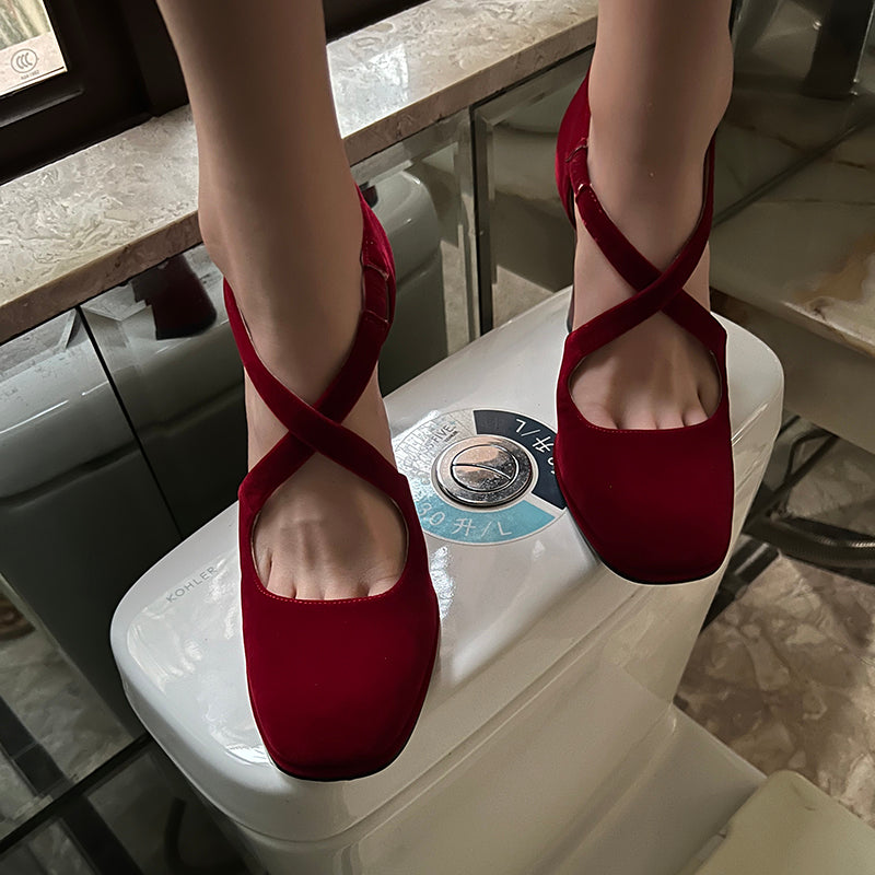 Red cross-strap round toe pumps