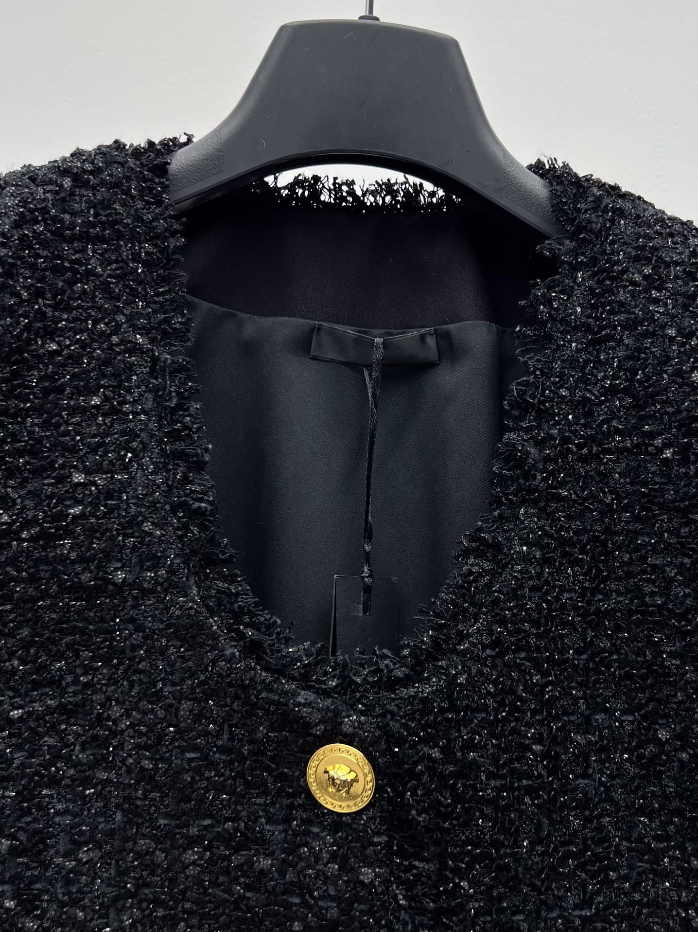 Tweed suit with gold buttons
